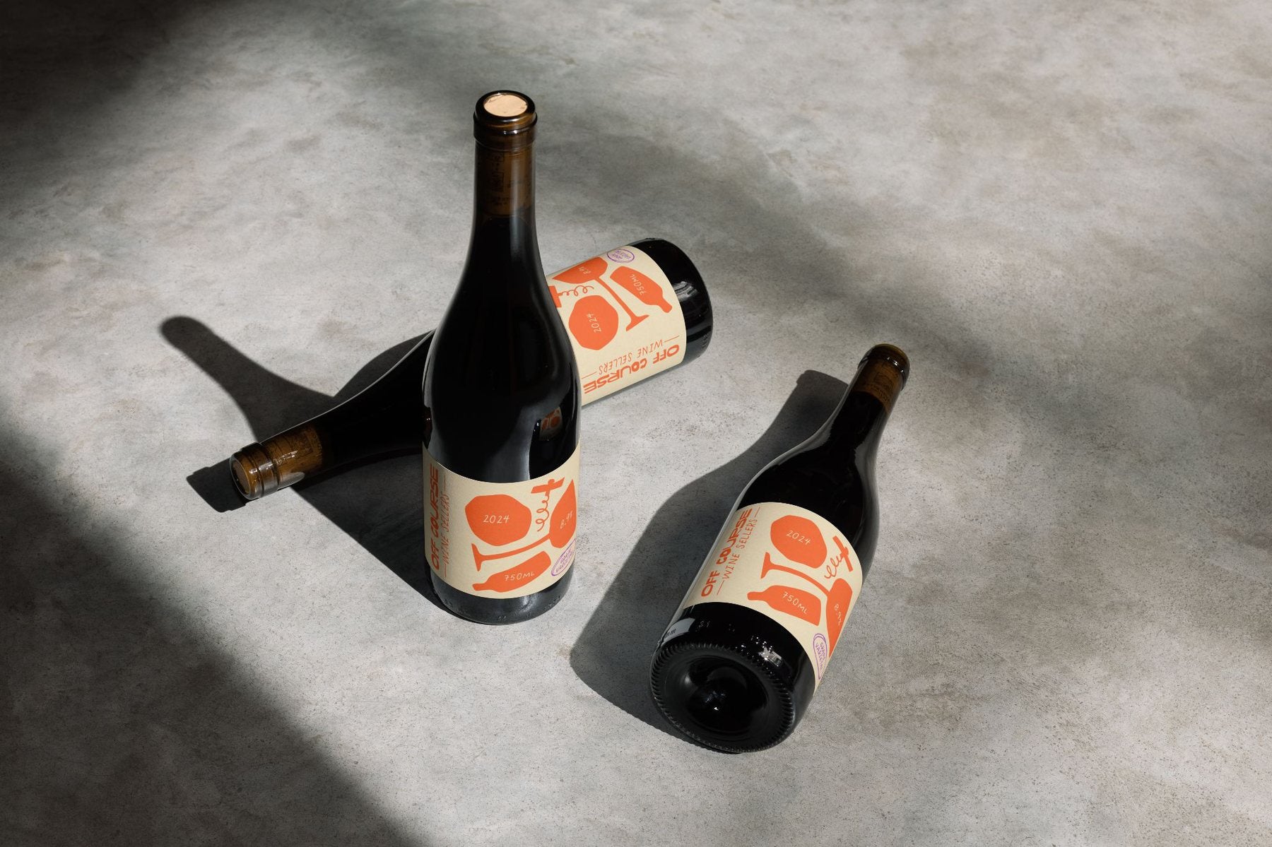 Off Course wine bottles with label concepts in dramatic sunlight